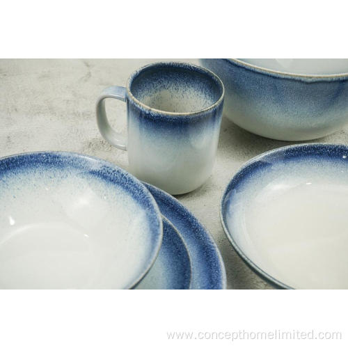 Reactive glazed stoneware dinner set with blue rim